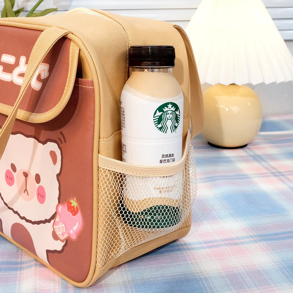 Starbucks drink in a cute bear-themed kawaii lunch bag on a checkered tablecloth