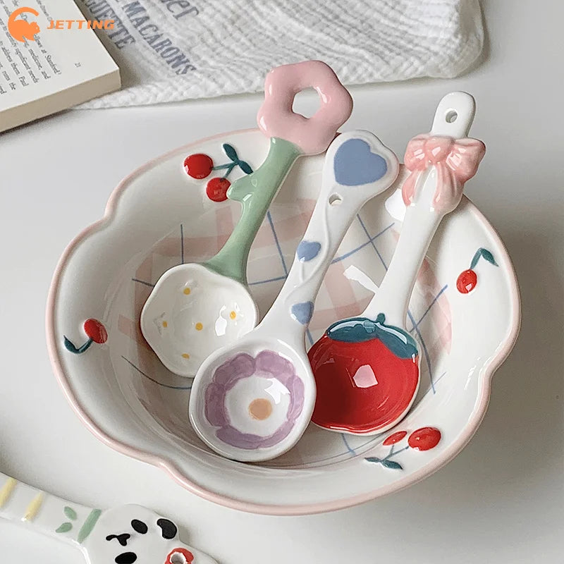 Three ceramic kawaii spoons sitting in a bowl