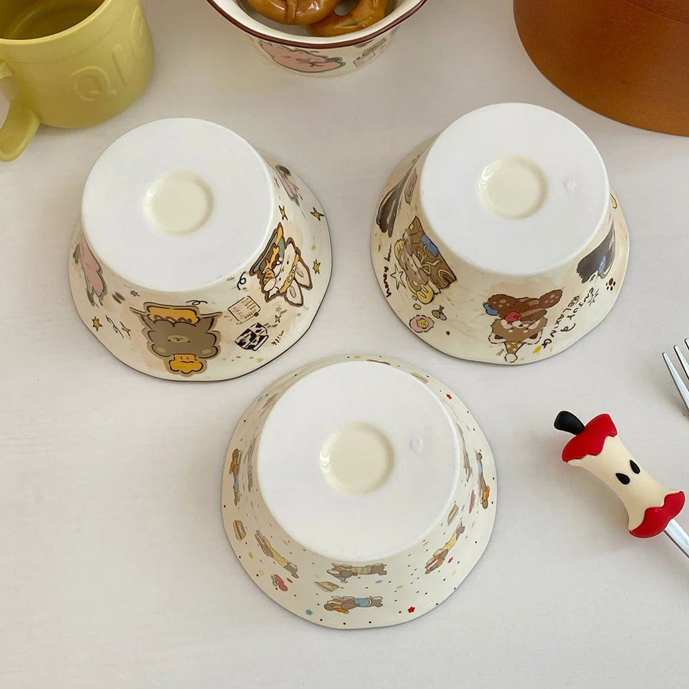 Three small ceramic kawaii ramen bowls with lids featuring animal illustrations on a light surface.