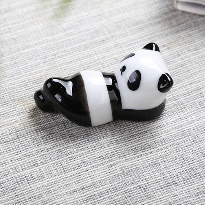 Panda-shaped kawaii chopstick holders on a textured surface with dimensions displayed