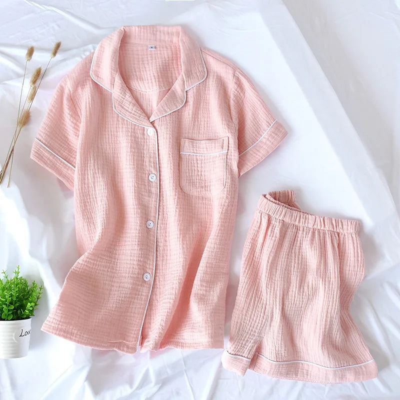 Pink kawaii pajama set on a white background with a small plant.
