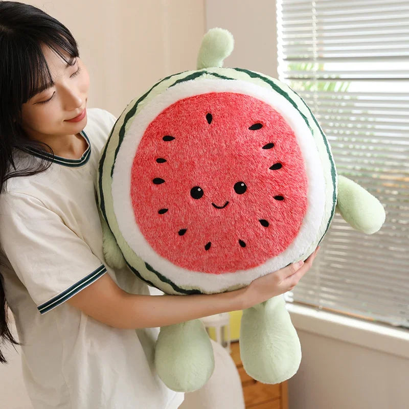 Person holding a kawaii plush watermelon pillow with a smiley face.