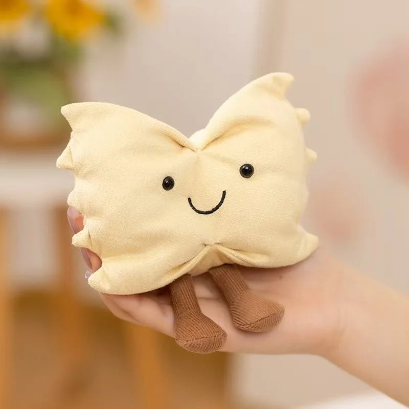 Hand holding a kawaii plush toy shaped like a dumpling with a smiling face.