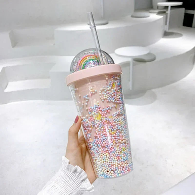 Clear kawaii tumbler with colorful beads and a rainbow design on a white background