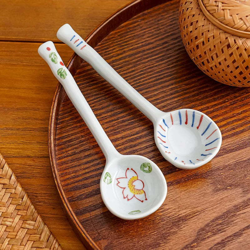 Two white ceramic kawaii spoons on the table