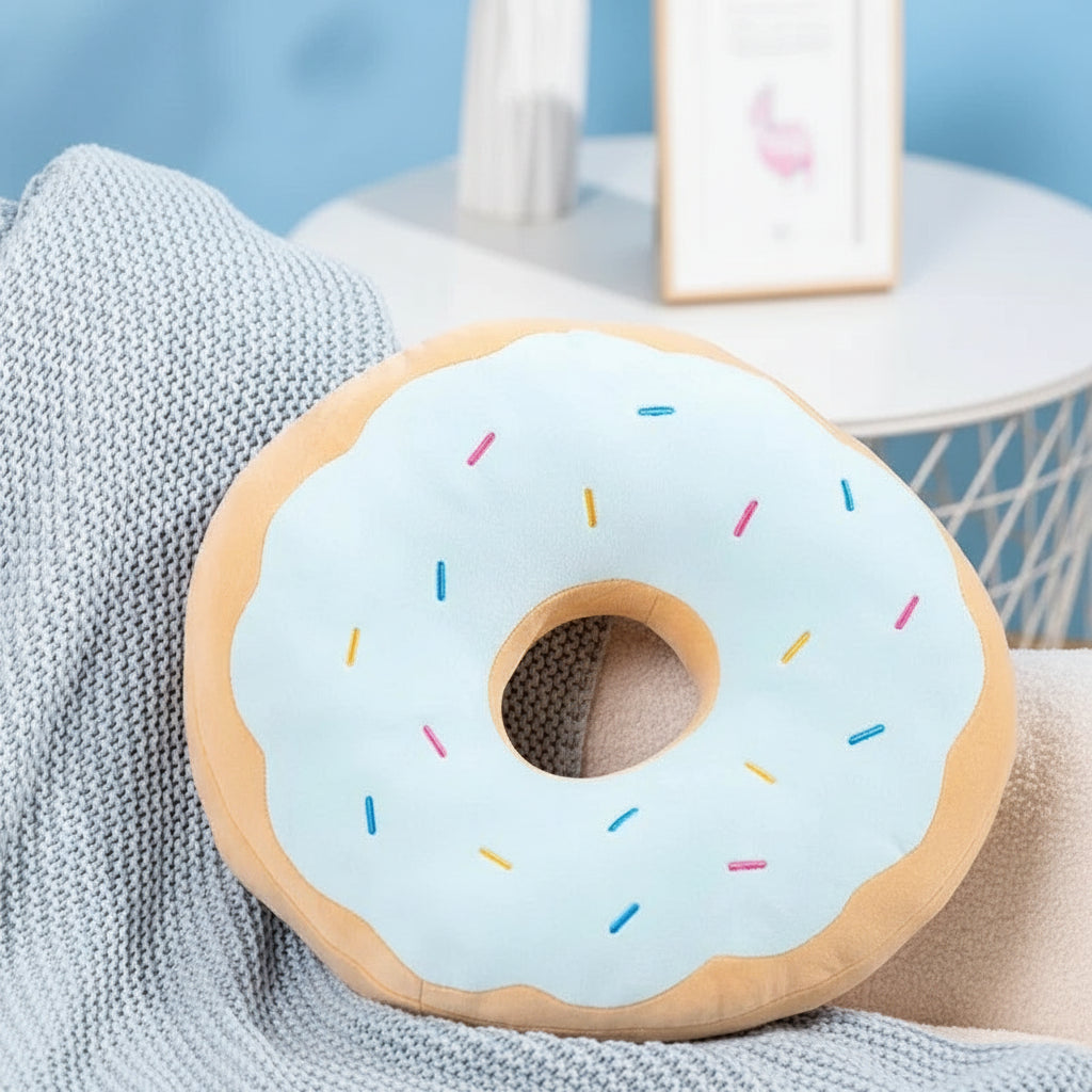 Donut-shaped kawaii cushion with blue icing and colorful sprinkles on a textured surface.