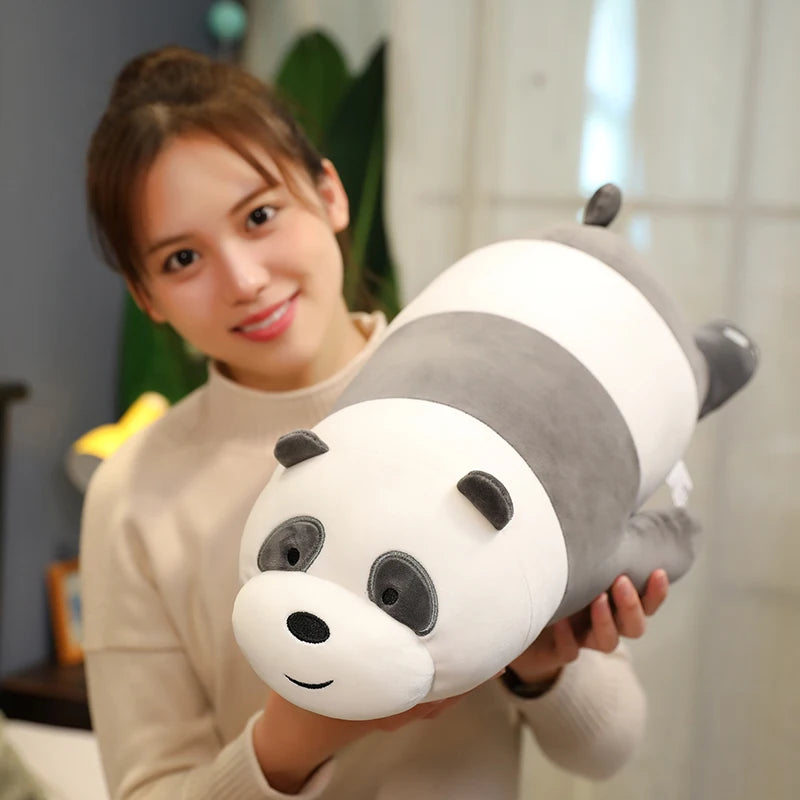 Person holding a large panda kawaii plush toy indoors