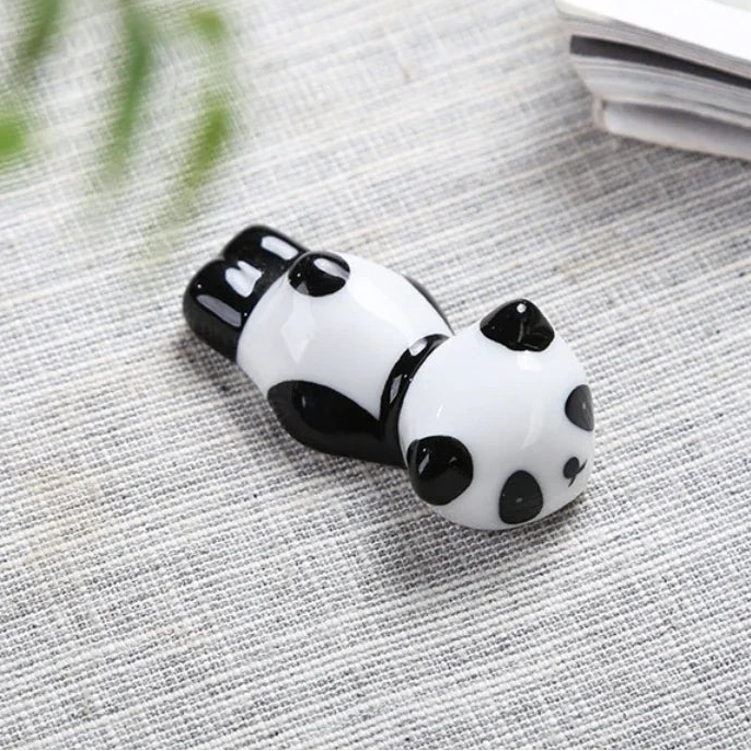 Panda-shaped kawaii chopstick holders on a textured surface with product dimensions displayed.