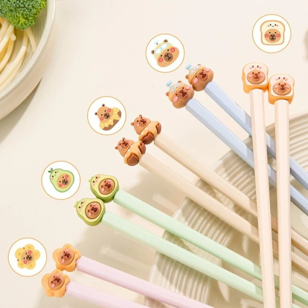 Set of novelty kawaii chopsticks with animal-themed tips on a light background
