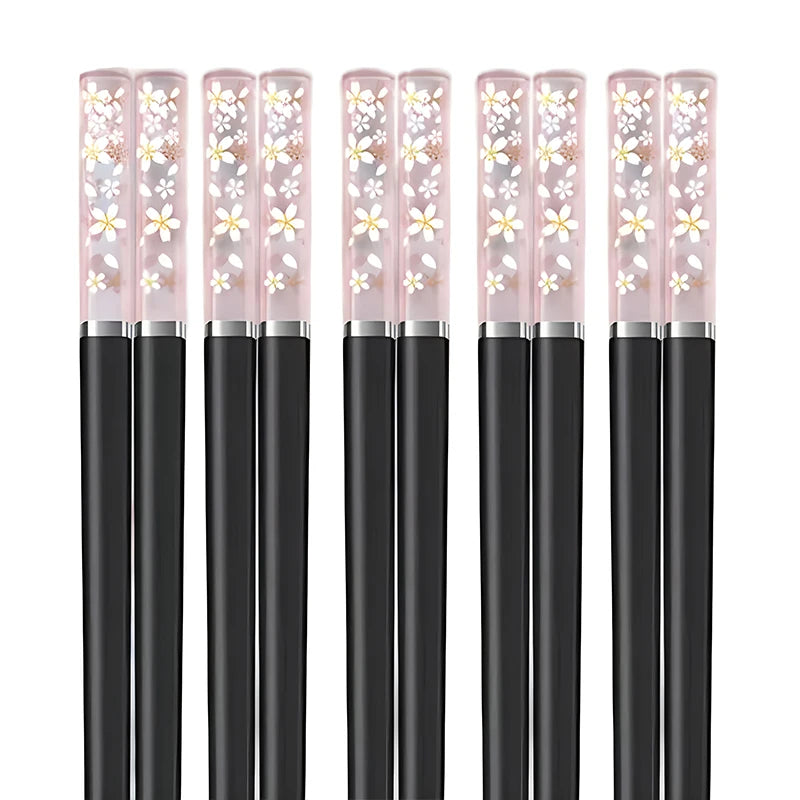Set of kawaii chopsticks with floral designs on the caps against a white background