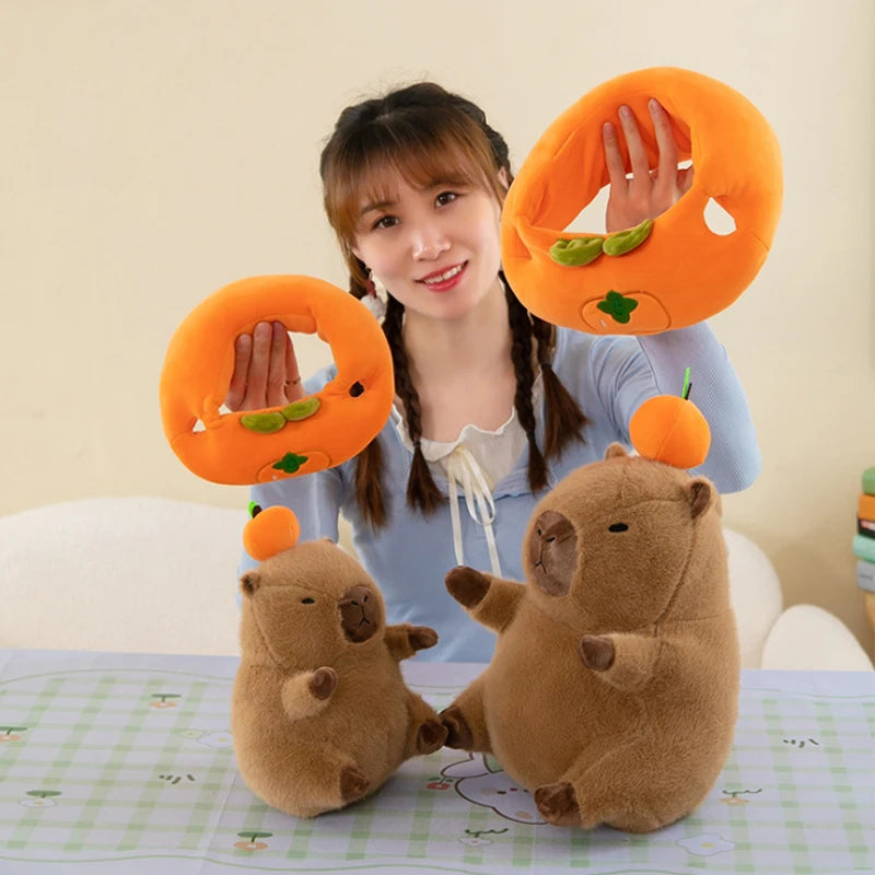 Person holding kawaii plush animal toys with orange rings on a light-colored background