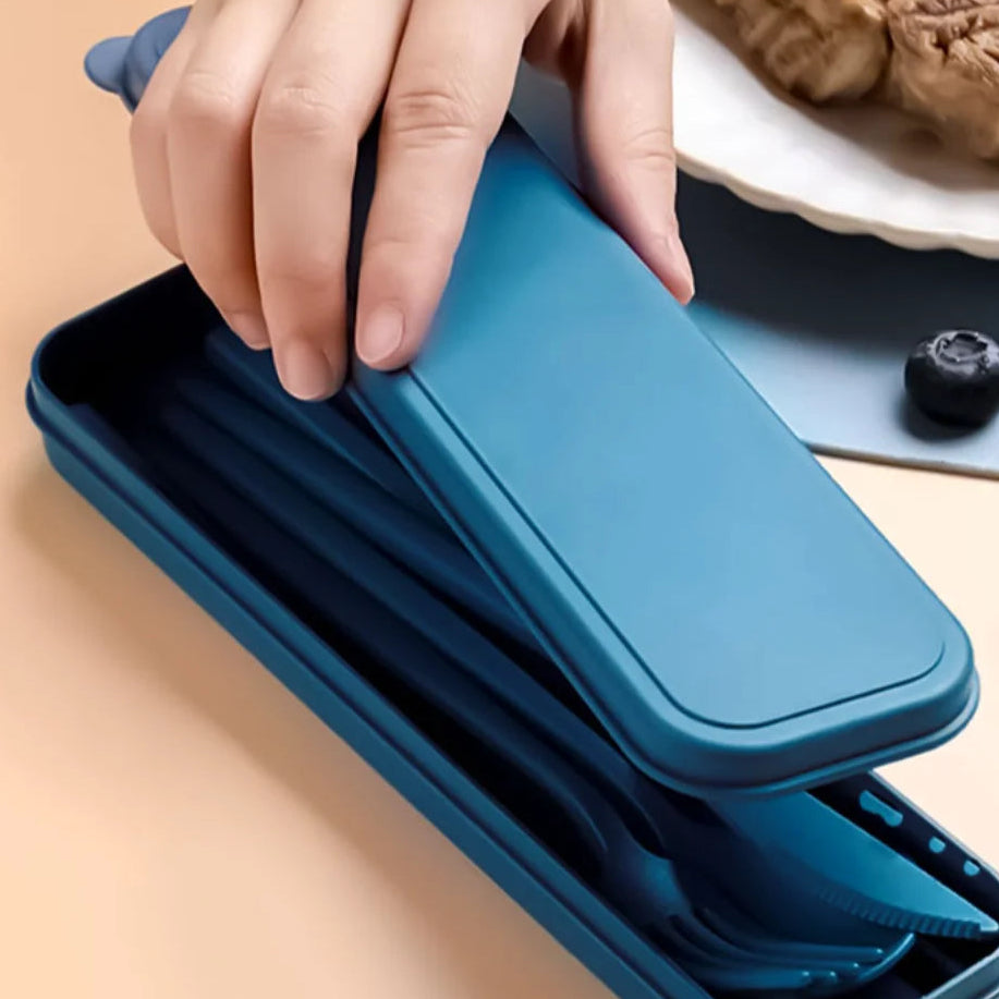 Blue silicone kawaii utensils being placed on a stack of blue silicone dishes with a hand holding one of them.