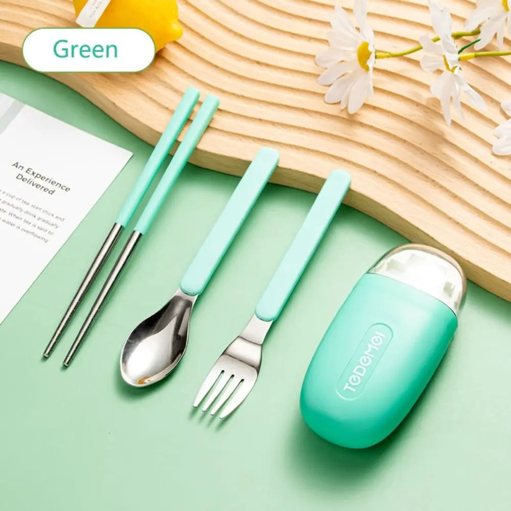 A set of green and steel kawaii utensils on a table