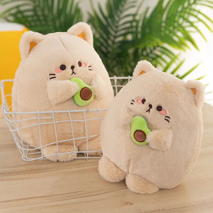 Two kawaii plush toys resembling cats with green avocados in a wire basket on a wooden surface.