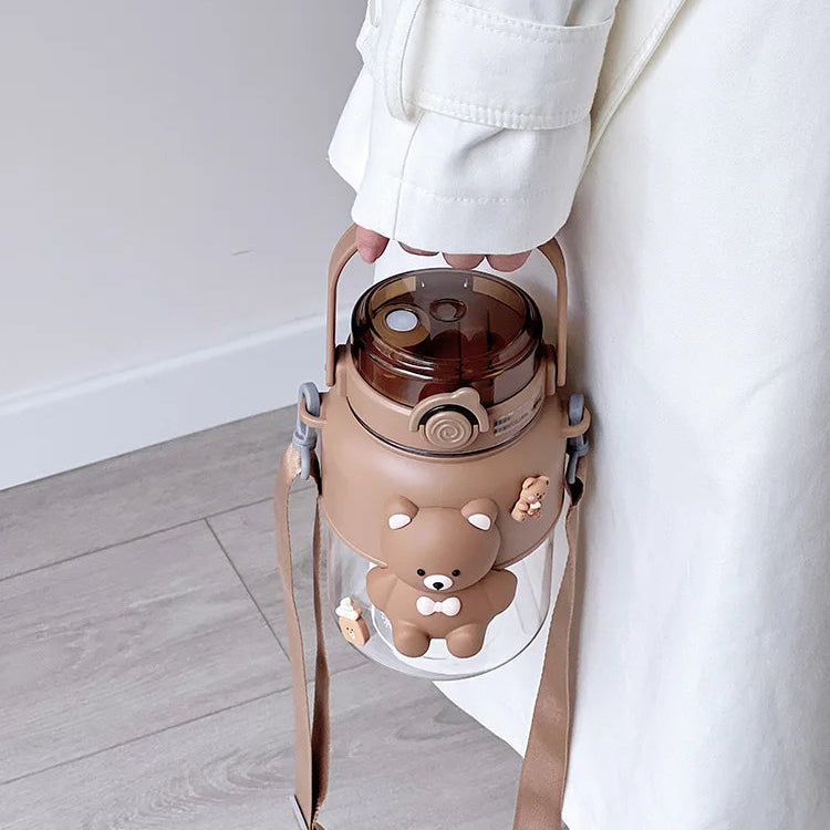 Person holding a kawaii bottle with a brown bear design against a white background