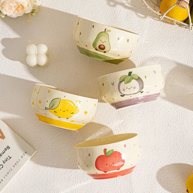 A group of four kawaii bowls of various cartoon designs on a table