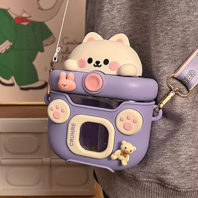 Cute camera-shaped kawaii water bottles with a bear design on a person's shoulder.