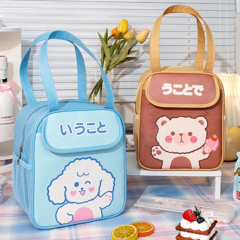 Two cute kawaii bags, one blue with a poodle design and the other brown with a bear design, on a checkered tablecloth.