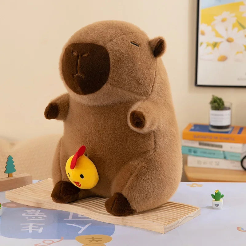 Kawaii plush toy resembling a beaver holding a yellow rubber duck on a table with a light-colored wall and books in the background.
