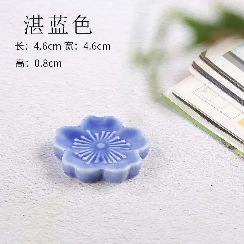 Blue flower-shaped kawaii chopstick holder on a textured surface with text overlay