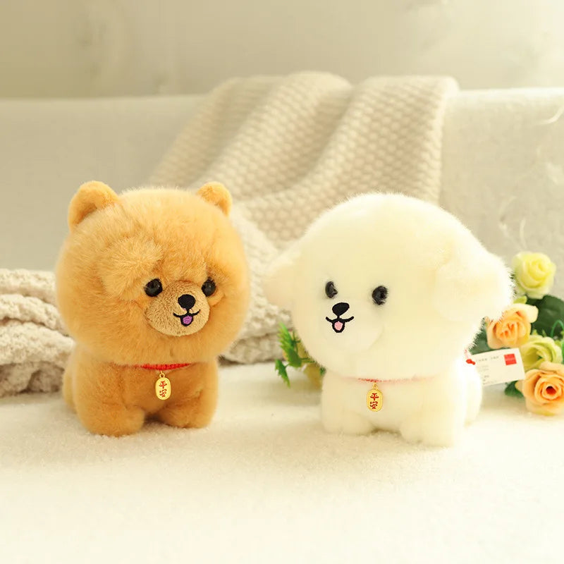 Two small kawaii plush toys, one brown and one white, sitting on a light surface with a blurred background.