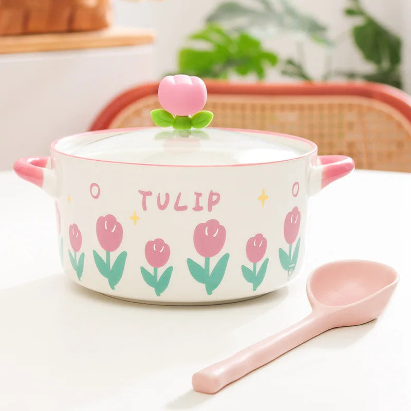 Ceramic kawaii ramen bowl with tulip design and pink lid knob on a white surface