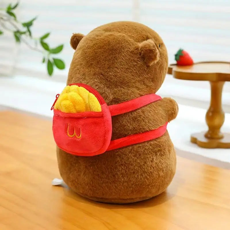 Kawaii plush bear with a red backpack on a wooden surface