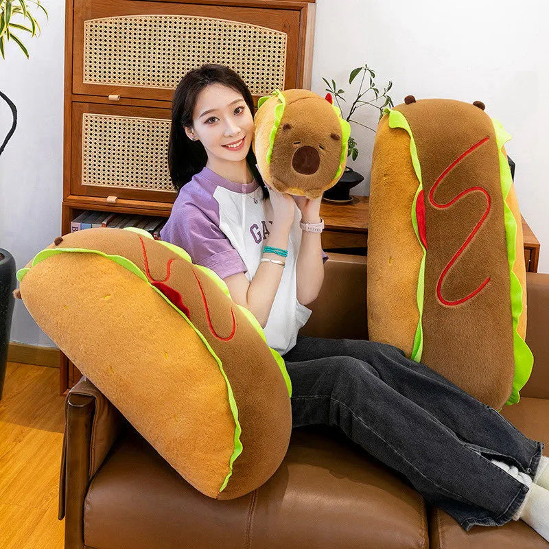 Person sitting on a couch with large hot dog-shaped kawaii cushions
