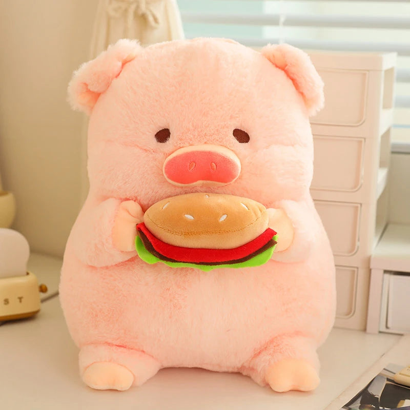 Kawaii plush toy pig holding a hamburger on a desk