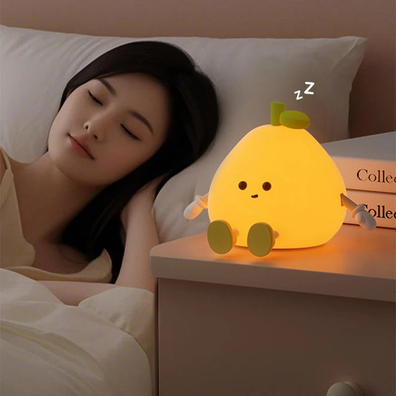 Woman lying in bed with a cartoon pear-shaped kawaii night light on the nightstand.