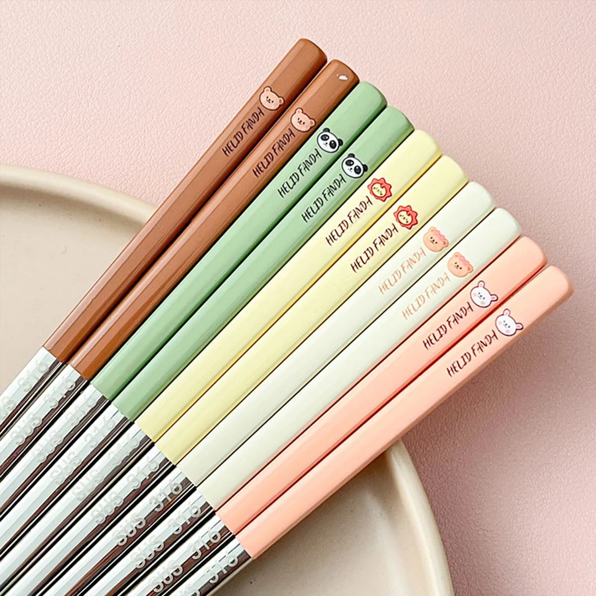 Set of colorful kawaii chopsticks with brand name on a pink background
