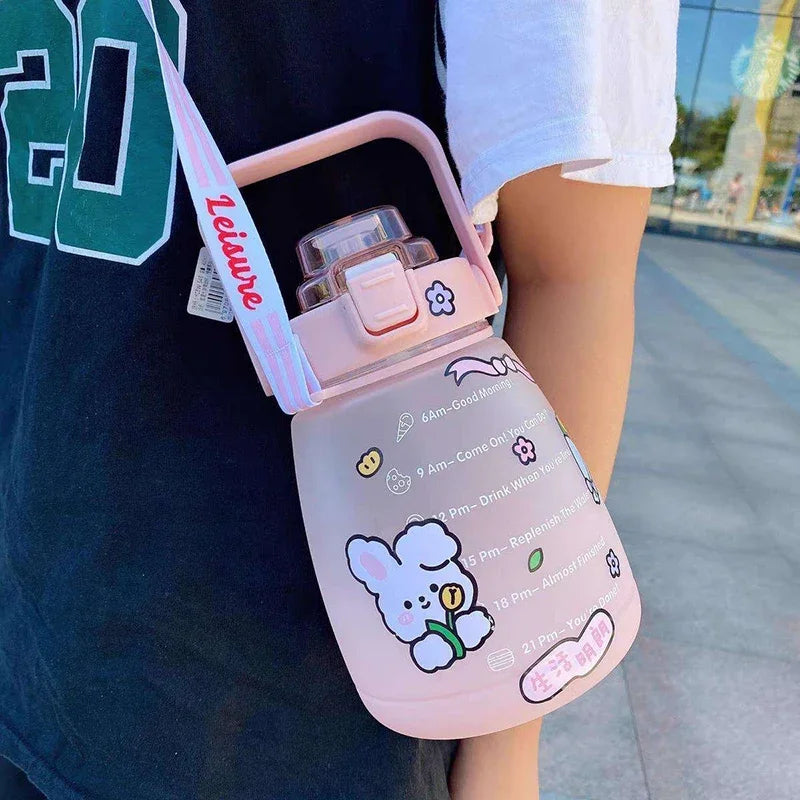 Pink kawaii water bottle with cartoon character design held by a person outdoors
