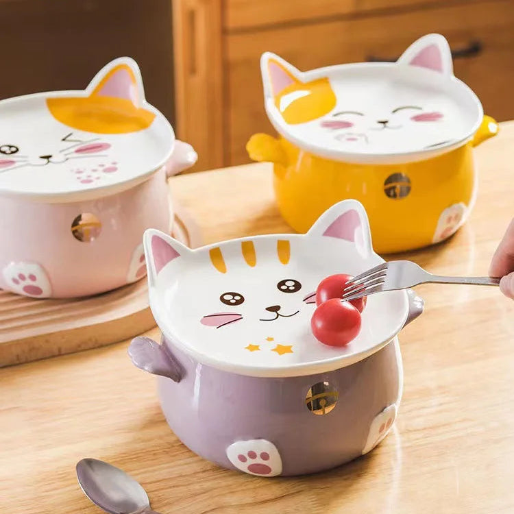 Three cartoon cat kawaii ramen bowls with lids on a wooden surface.