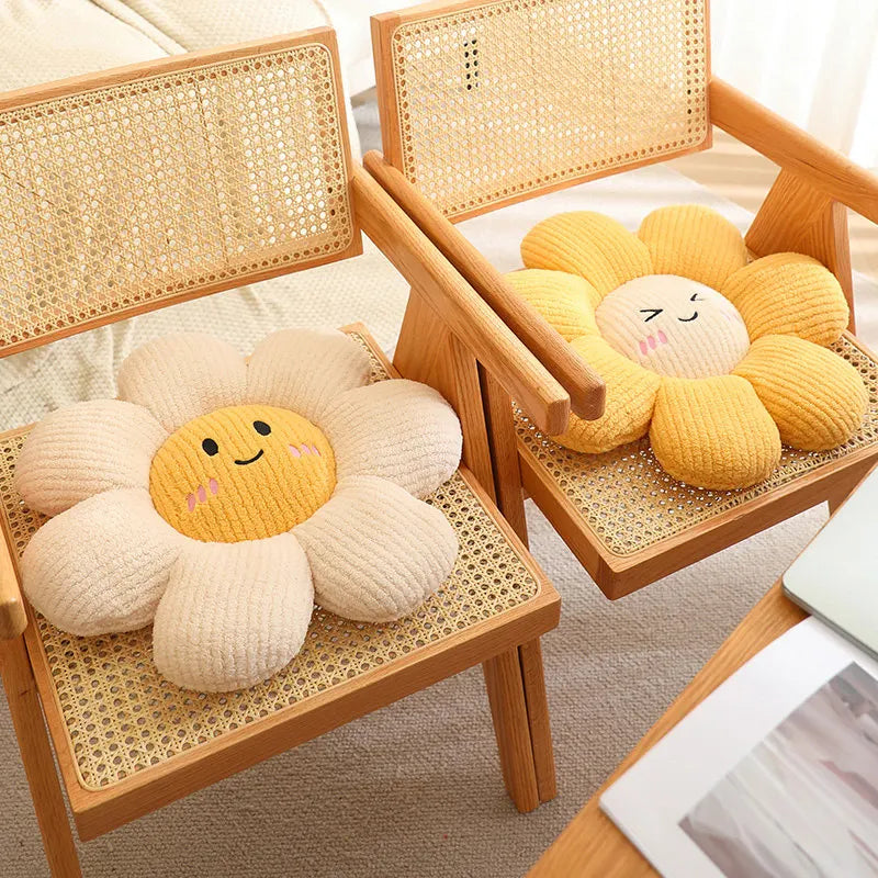 Two knitted sunflower-shaped kawaii cushions on wicker chairs with a blurred photo frame in the foreground.