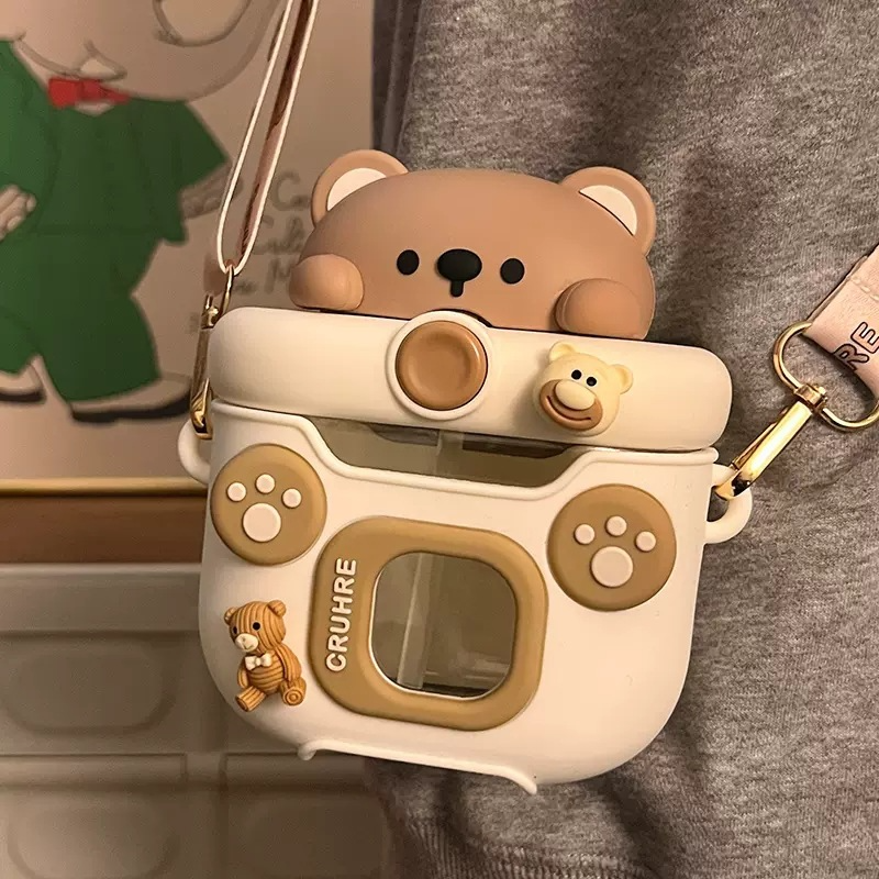 Cute camera-shaped kawaii water bottles with bear design on a gray background