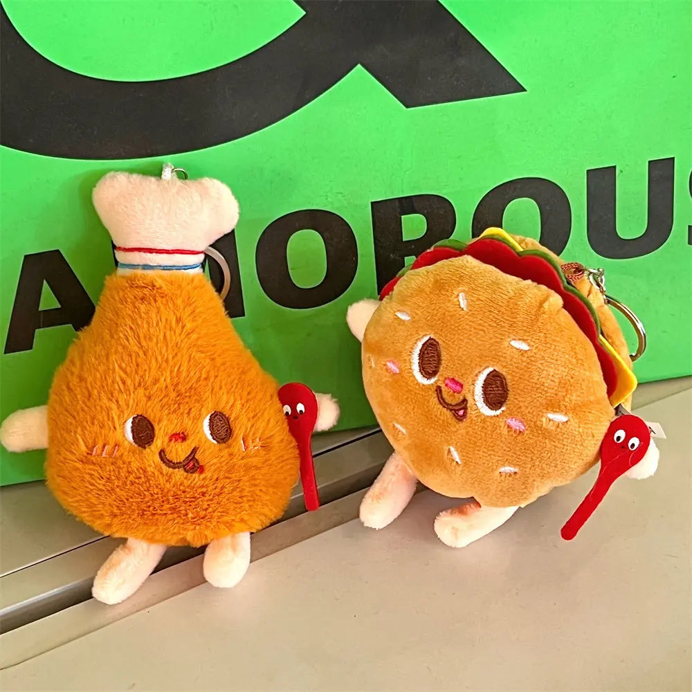 Two kawaii plush toys shaped like a chicken drumstick and a taco with a green background.