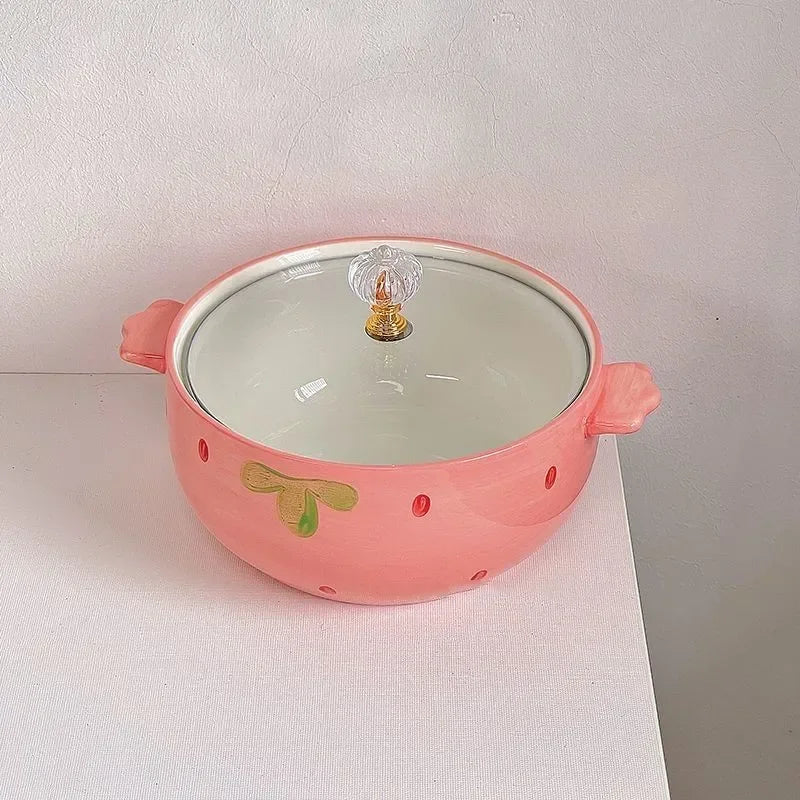 Pink ceramic kawaii bowls with a clear glass lid on a white surface