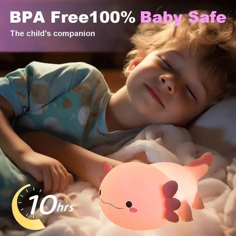 Child lying down with a pink axolotl-shaped kawaii night light, emphasizing 'BPA Free 100% Baby Safe' and 'The child's companion'.