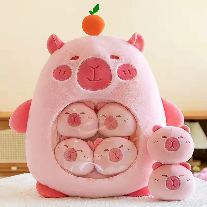 Pink kawaii plush toy resembling a pig with smaller pig plushies inside, on a light background.