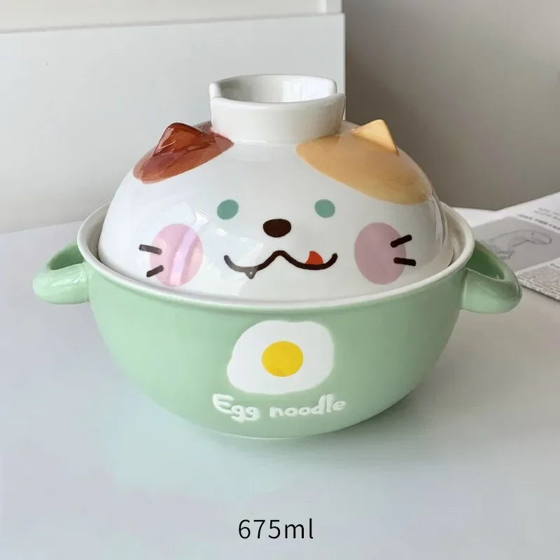 Cute ceramic kawaii ramen bowl with cartoon face design on a white surface