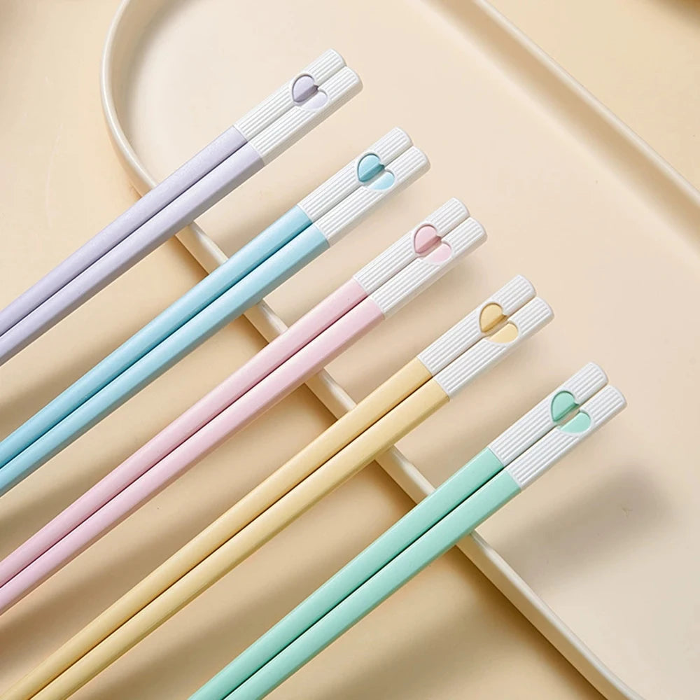 Set of colorful kawaii chopsticks on a beige background