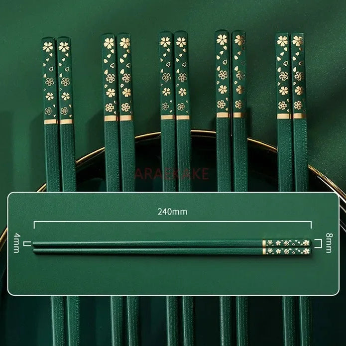 Set of green kawaii chopsticks with floral patterns on a green background