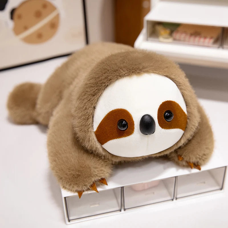 Kawaii plush sloth toy on a white surface with a blurred background