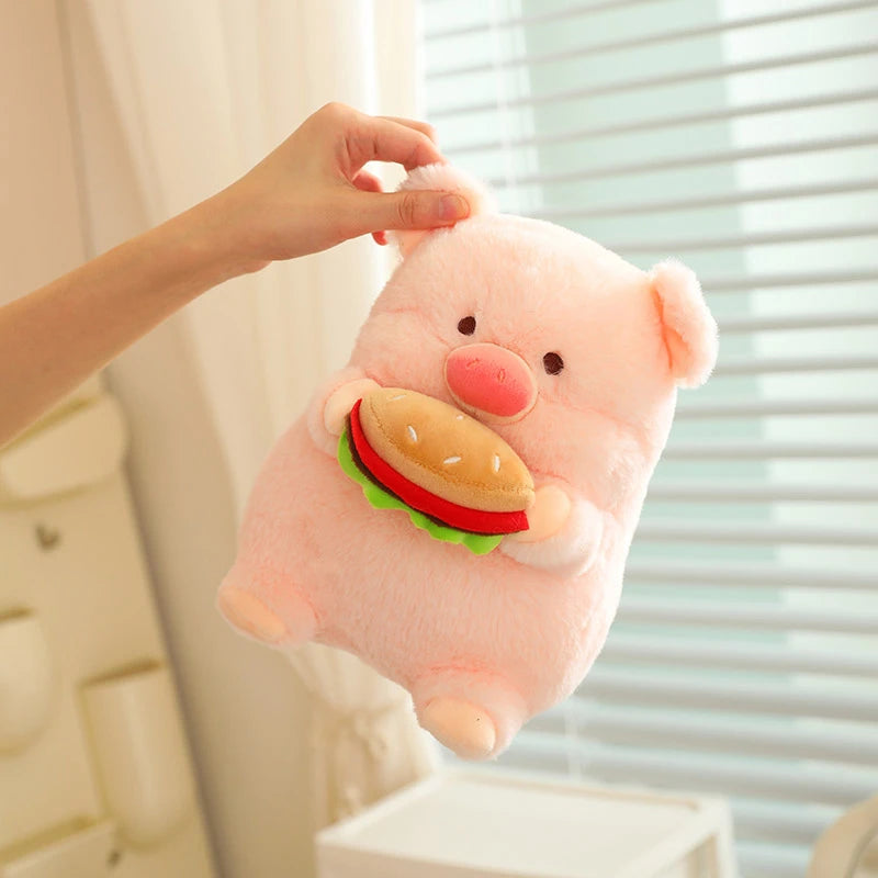 Kawaii plush toy shaped like a pig with a hamburger on its chest, held by a hand.