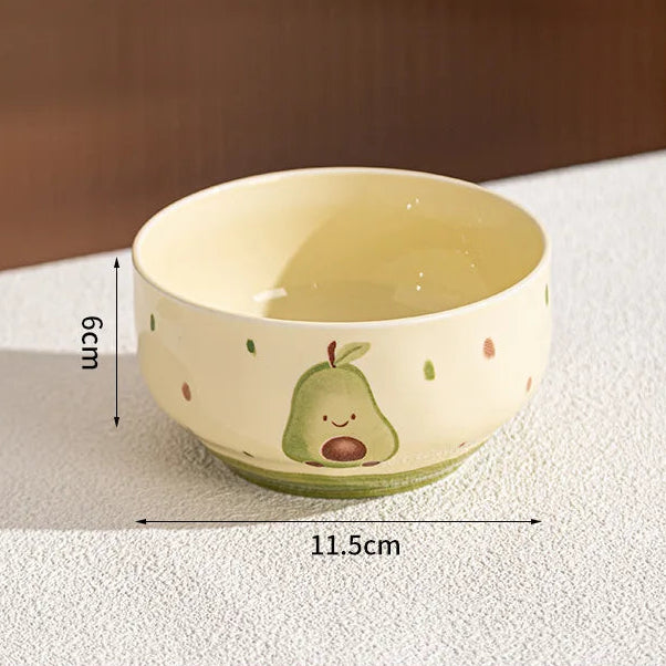 Small ceramic kawaii bowl with avocado design on a white surface, showing dimensions.