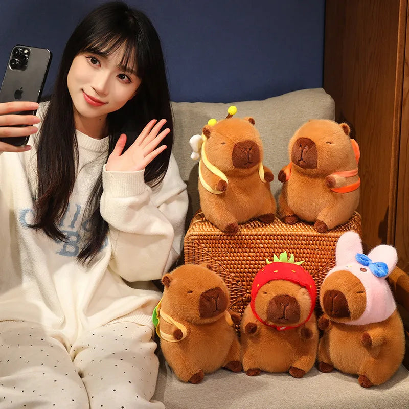 Woman taking a selfie with kawaii plush toy beavers on a couch
