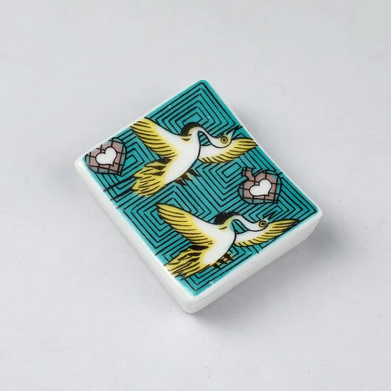 A square kawaii chopstick holder with a bird design