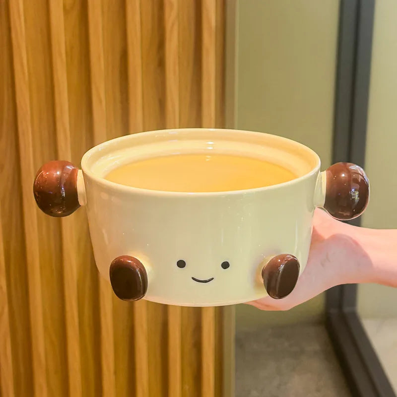 A cute smiley face kawaii bowl being held by someone