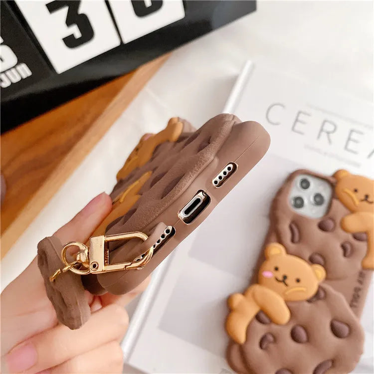 Phone case with kawaii bear design held by a hand, with another case in the background.