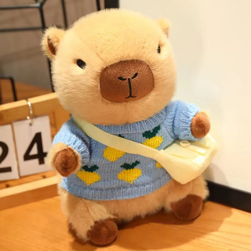 Kawaii plush bear toy wearing a blue sweater with lemon designs on a wooden surface.